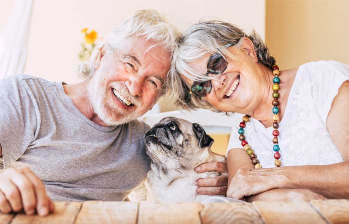 Smiling couple with dog
